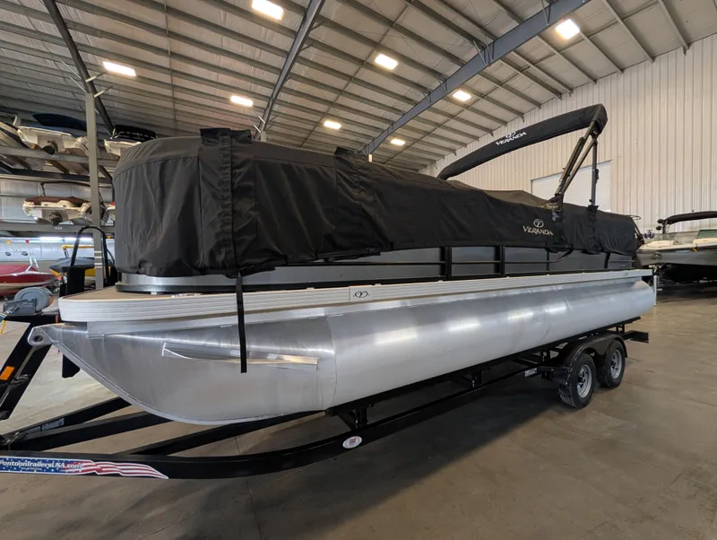 Slide: The Image of 2021 Veranda pontoon boat in warehouse, covered and on trailer. - 10