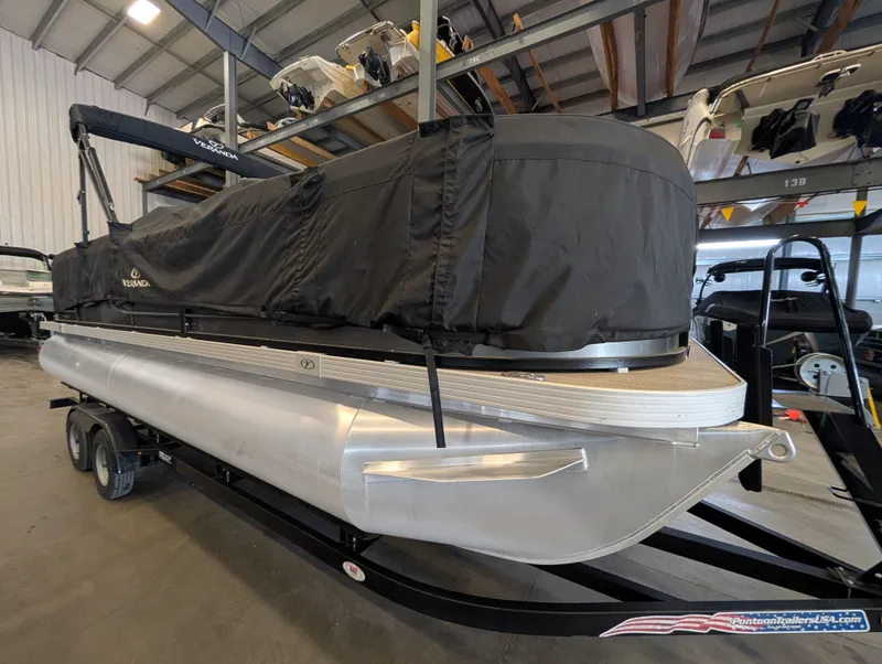 Slide: The Image of 2021 Veranda pontoon boat in warehouse, covered and on trailer. - 11