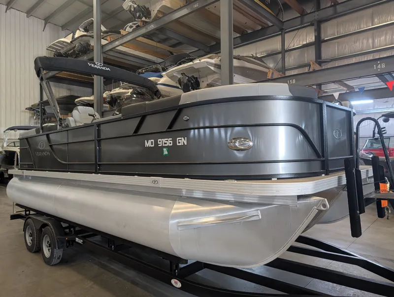 Slide: The Image of 2021 Veranda pontoon boat in warehouse on trailer. - 12