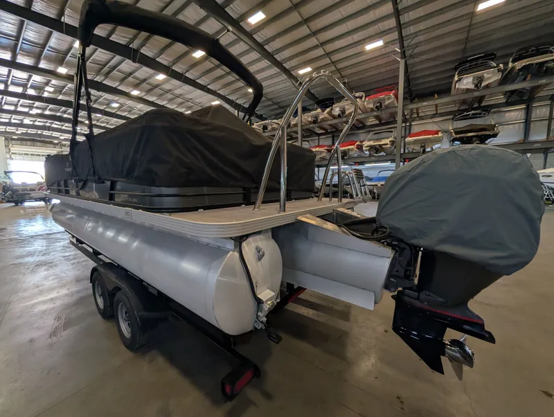 Slide: The Image of 2021 Veranda pontoon boat in warehouse, covered and on trailer. - 14