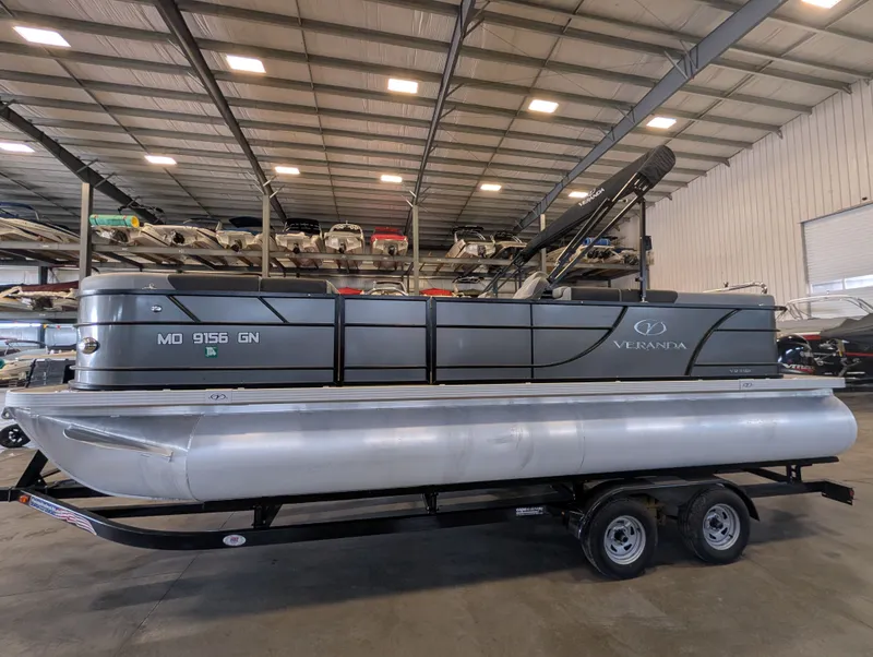 Slide: The Image of 2021 Veranda pontoon boat in warehouse on trailer. - 8