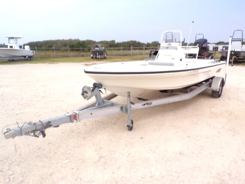 Slide: The Image of 2022 Mako 18 LTS boat on trailer parked outdoors. - 14