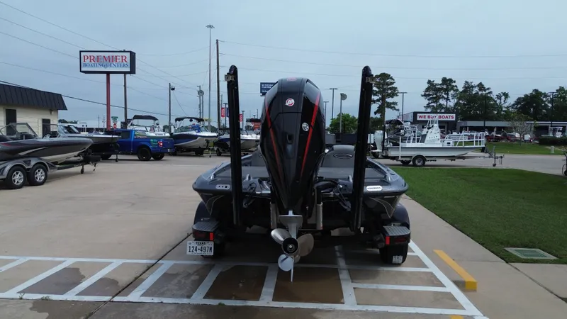 Slide: The Image of Rear view of a 2021 Phoenix 921 Elite boat at a boating center. - 12