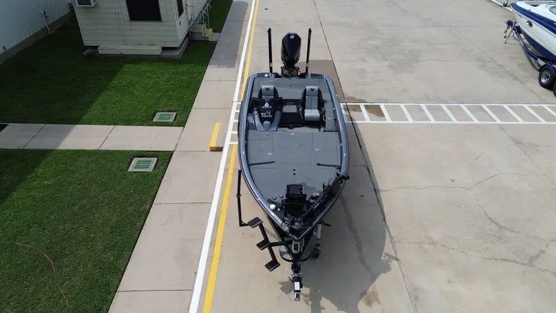 Slide: The Image of Aerial view of a 2021 Phoenix 921 Elite boat on a parking lot. - 28