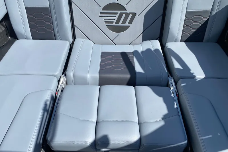 Slide: The Image of 2025 Malibu Wakesetter 23 LSV interior seating with stylish upholstery and logo detail. - 13