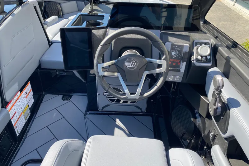 Slide: The Image of 2025 Malibu Wakesetter 23 LSV cockpit with modern steering and digital controls. - 16
