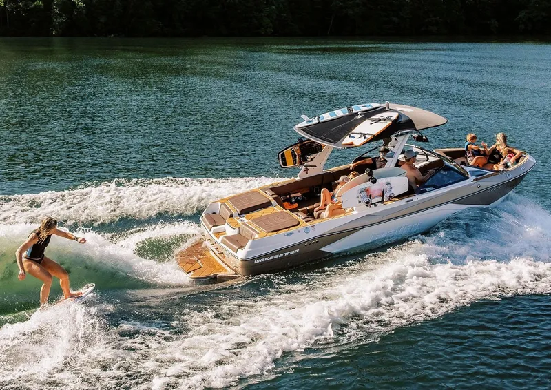 Slide: The Image of Manufacturer Provided Image: 2025 Malibu Wakesetter 23 LSV towing a wakeboarder on a sunny lake. - 18