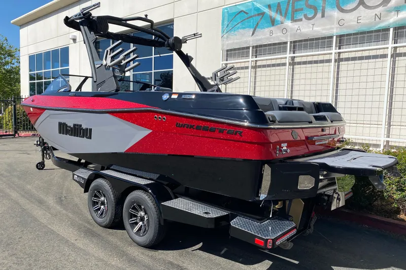 Slide: The Image of 2025 Malibu Wakesetter 23 LSV boat in red and black at West Coast Boat Center. - 4