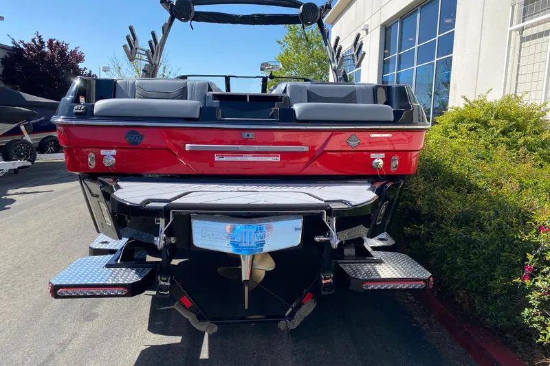 Slide: The Image of 2025 Malibu Wakesetter 23 LSV boat, rear view, red exterior, parked outdoors. - 6