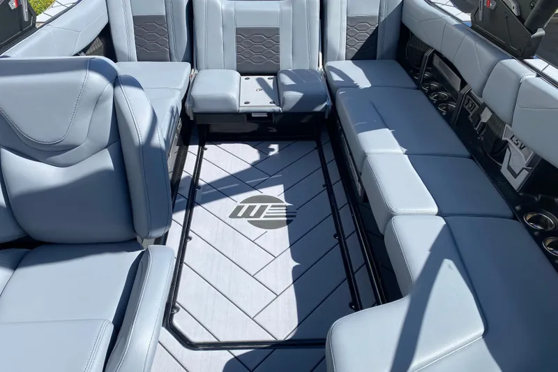 Slide: The Image of 2025 Malibu Wakesetter 23 LSV interior with sleek gray seating and stylish flooring. - 9