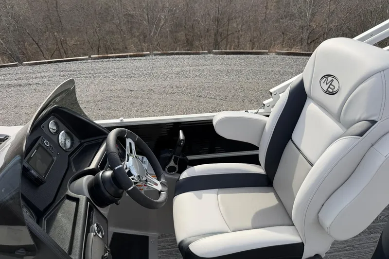Slide: The Image of Captain's seat and dashboard of 2026 Montego Bay 140HP boat, featuring sleek design and controls. - 14