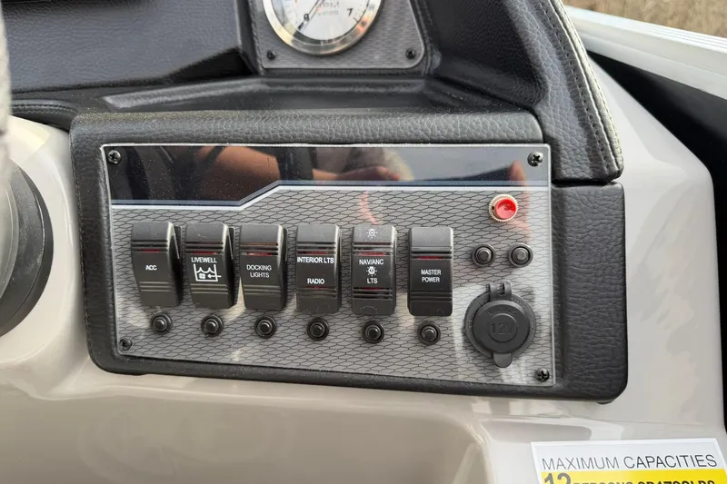 Slide: The Image of Control panel of a 2026 Montego Bay 140HP boat with various switches and gauges. - 19