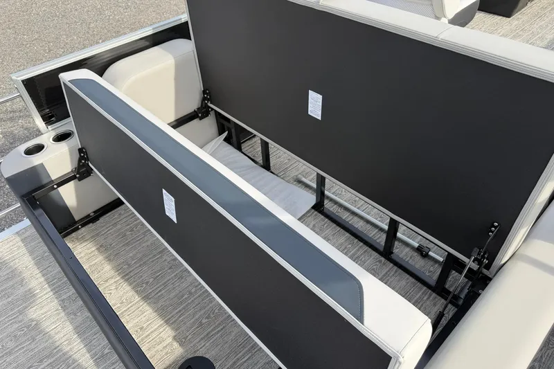 Slide: The Image of 2026 Montego Bay 140HP boat interior with open storage compartments and cup holders. - 27