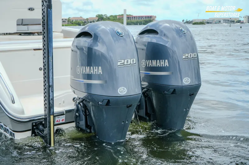 Slide: The Image of 2016 Pursuit C 260 Center Console with twin Yamaha 200 engines in water. - 1