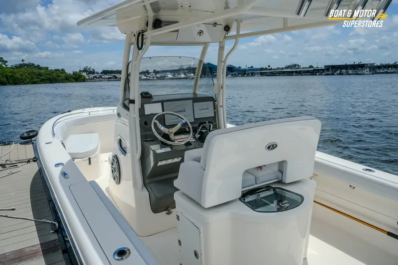 Slide: The Image of 2016 Pursuit C 260 Center Console boat docked by the water. - 10