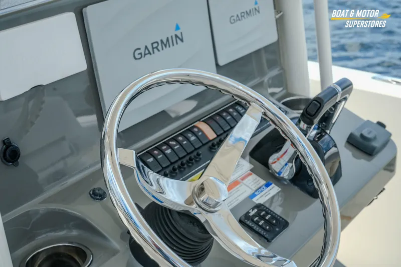 Slide: The Image of 2016 Pursuit C 260 Center Console helm with Garmin navigation and chrome steering wheel. - 15