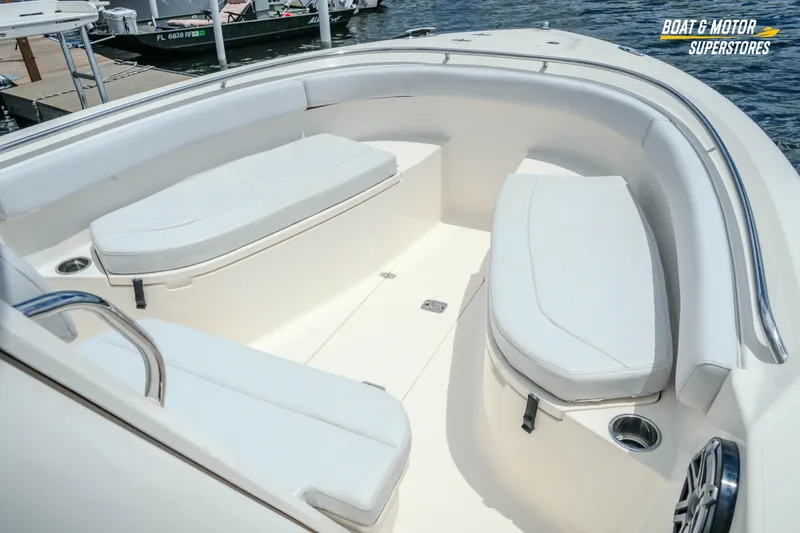 Slide: The Image of 2016 Pursuit C 260 Center Console boat interior with cushioned seating and stainless steel accents. - 16