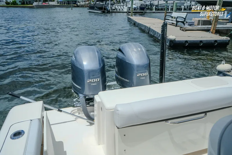 Slide: The Image of 2016 Pursuit C 260 Center Console with twin Yamaha 200 engines docked by the water. - 17
