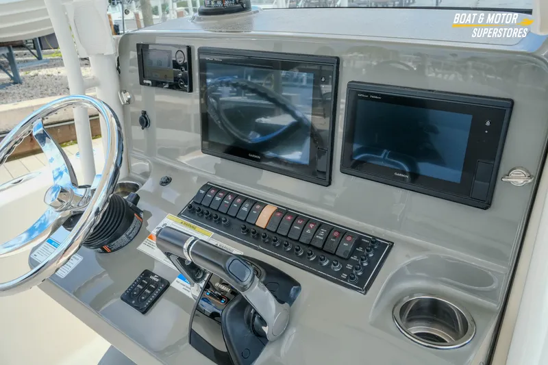 Slide: The Image of 2016 Pursuit C 260 Center Console dashboard with Garmin displays and controls. - 19
