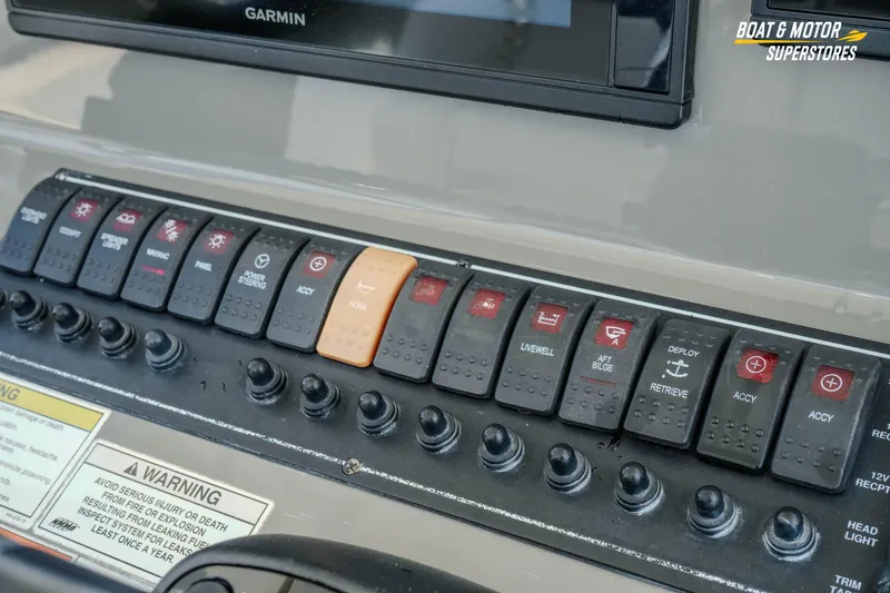 Slide: The Image of Control panel of a 2016 Pursuit C 260 Center Console boat with labeled switches. - 20
