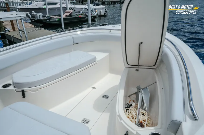 Slide: The Image of 2016 Pursuit C 260 Center Console boat interior with open storage compartment and anchor. - 23