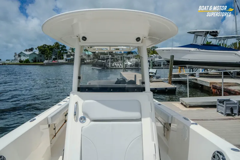 Slide: The Image of 2016 Pursuit C 260 Center Console boat docked at marina under cloudy sky. - 24