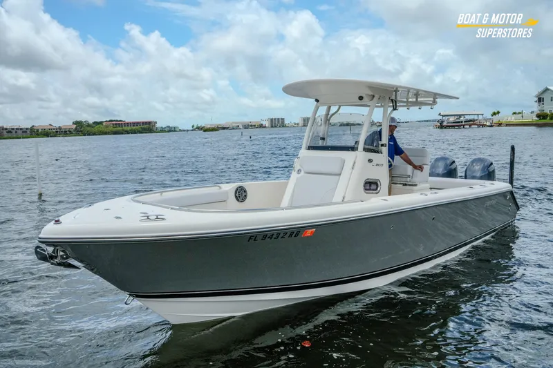 Slide: The Image of 2016 Pursuit C 260 Center Console boat on a calm lake under cloudy skies. - 27