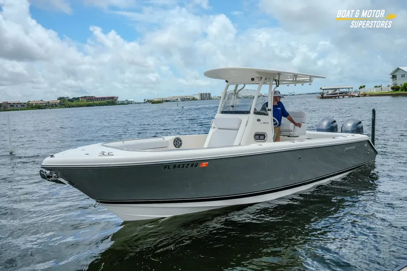 Slide: The Image of 2016 Pursuit C 260 Center Console boat on water, under cloudy sky. - 28