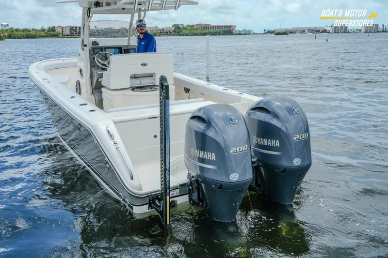 Slide: The Image of 2016 Pursuit C 260 Center Console boat with dual Yamaha 200 engines on water. - 30