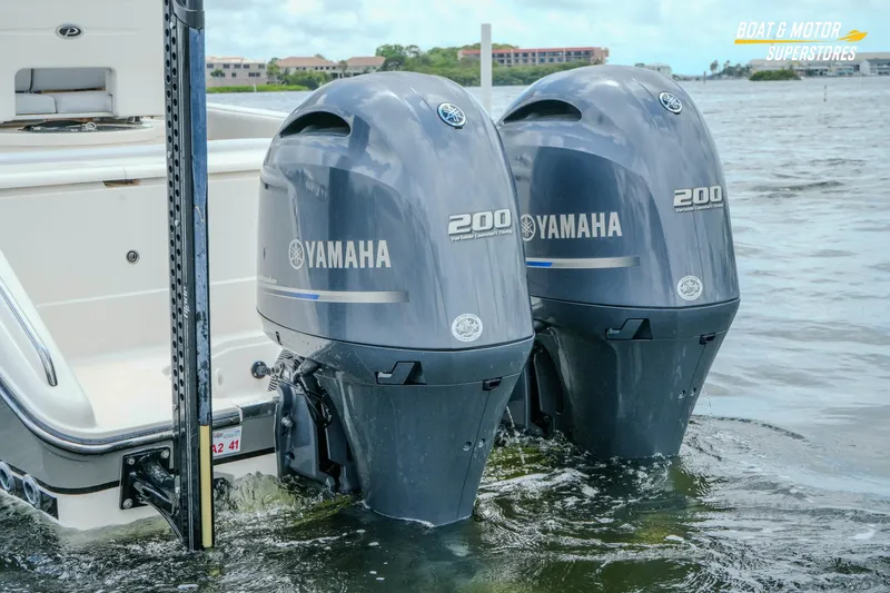 Slide: The Image of 2016 Pursuit C 260 Center Console with twin Yamaha 200 engines in water. - 31