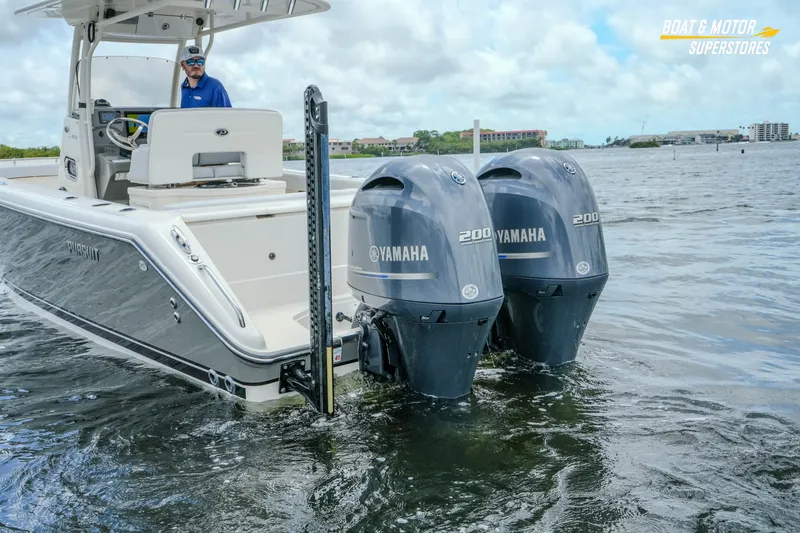 Slide: The Image of 2016 Pursuit C 260 Center Console boat with twin Yamaha 200 engines on water. - 32