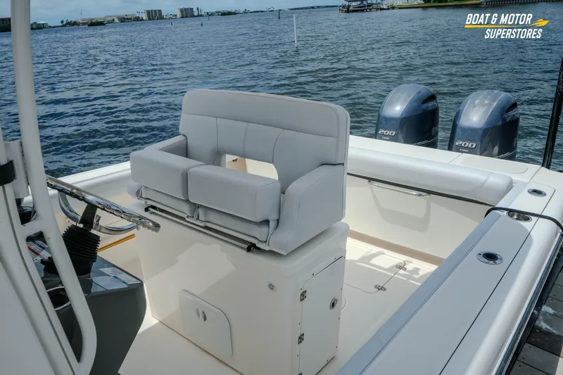 Slide: The Image of 2016 Pursuit C 260 Center Console boat with dual engines on a calm water backdrop. - 6