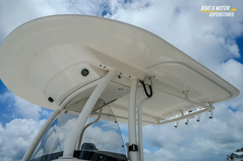 Slide: The Image of 2016 Pursuit C 260 Center Console boat top against a cloudy sky. - 7