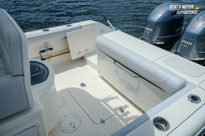 Slide: The Image of 2016 Pursuit C 260 Center Console boat interior with Yamaha engines, featuring seating and storage. - 8