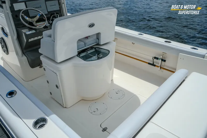 Slide: The Image of 2016 Pursuit C 260 Center Console boat interior with helm and seating area. - 9