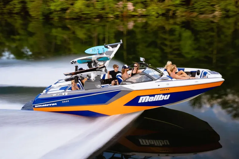 Slide: The Image of Manufacturer Provided Image: 2025 Malibu Wakesetter 23 MXZ speeding on a lake with passengers enjoying the ride. - 10