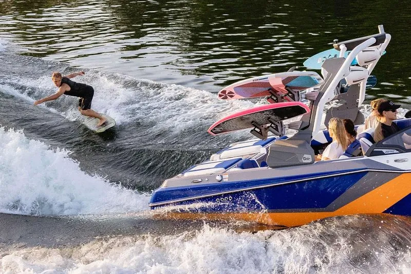 Slide: The Image of Manufacturer Provided Image: 2025 Malibu Wakesetter 23 MXZ towing a wakeboarder on a sunny day. - 11