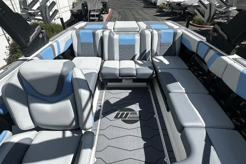 Slide: The Image of 2025 Malibu Wakesetter 23 MXZ interior with stylish gray and blue seating. - 6