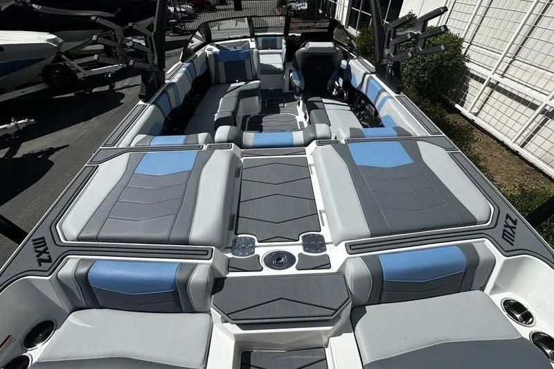 Slide: The Image of 2025 Malibu Wakesetter 23 MXZ boat interior with gray and blue seating. - 7
