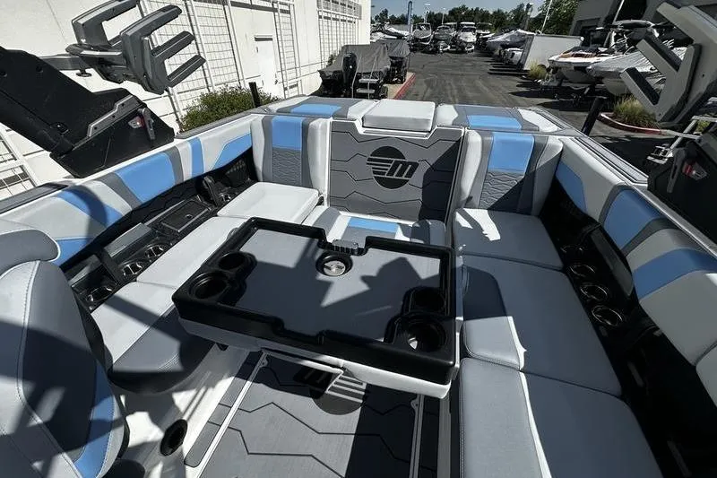 Slide: The Image of Interior of 2025 Malibu Wakesetter 23 MXZ boat with stylish seating and table. - 9