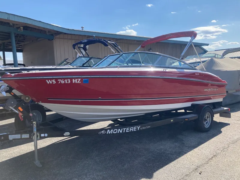 The Image of Red 2012 Monterey 204FS boat on trailer outdoors. - 0