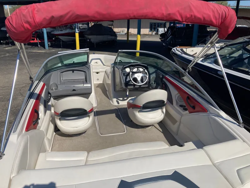 Slide: The Image of Interior of a 2012 Monterey 204FS boat with red sunshade. - 11