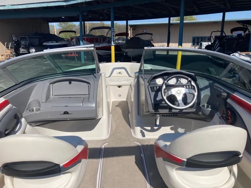 Slide: The Image of Interior of a 2012 Monterey 204FS boat with steering console. - 12
