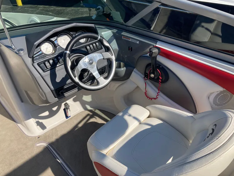 Slide: The Image of Interior of a 2012 Monterey 204FS boat with steering wheel and dashboard. - 14