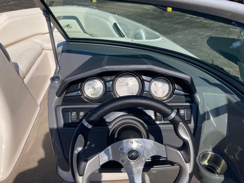 Slide: The Image of Dashboard of a 2012 Monterey 204FS boat with steering wheel and gauges. - 15