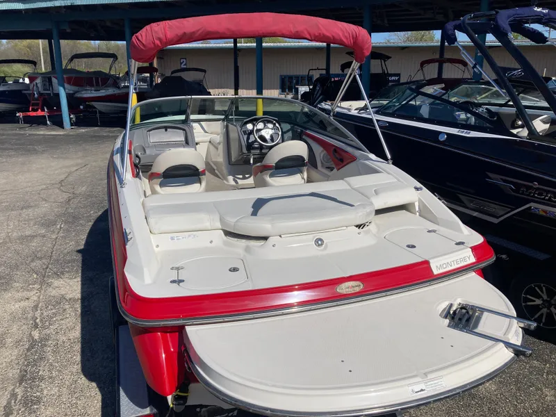 Slide: The Image of 2012 Monterey 204FS boat with red canopy in marina. - 3