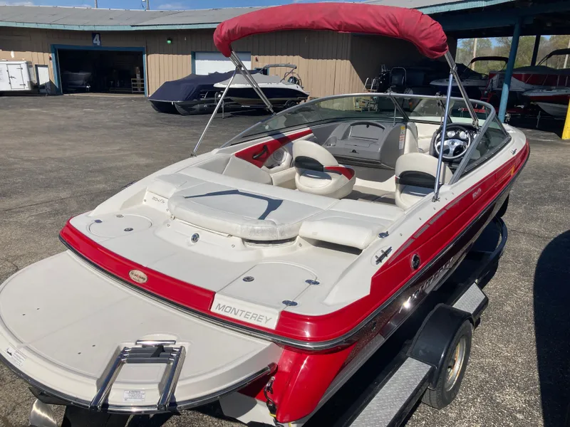 Slide: The Image of 2012 Monterey 204FS boat with red canopy on trailer. - 4
