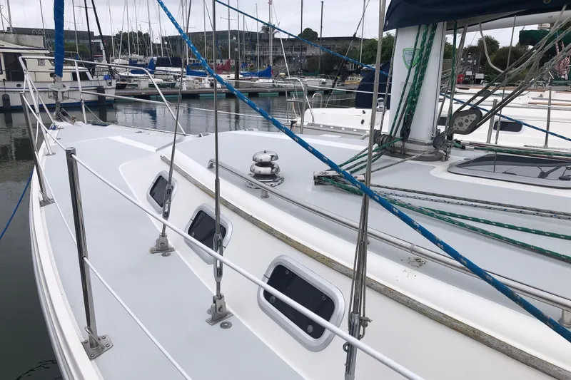 Slide: The Image of Sailboat Catalina 34, 1992 model, docked in marina with visible rigging and deck details. - 12