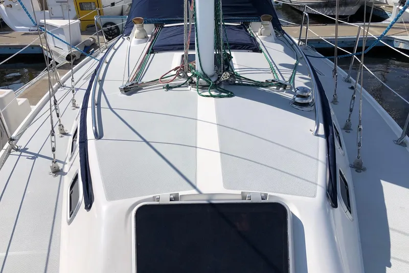 Slide: The Image of Deck view of a 1992 Catalina 34 sailboat, featuring rigging and winches. - 13