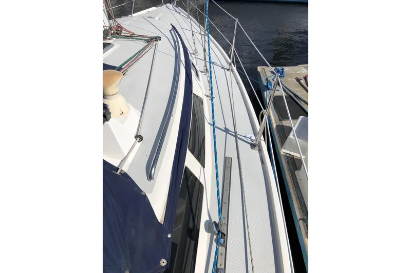 Slide: The Image of Deck view of a 1992 Catalina 34 sailboat docked at a marina. - 14